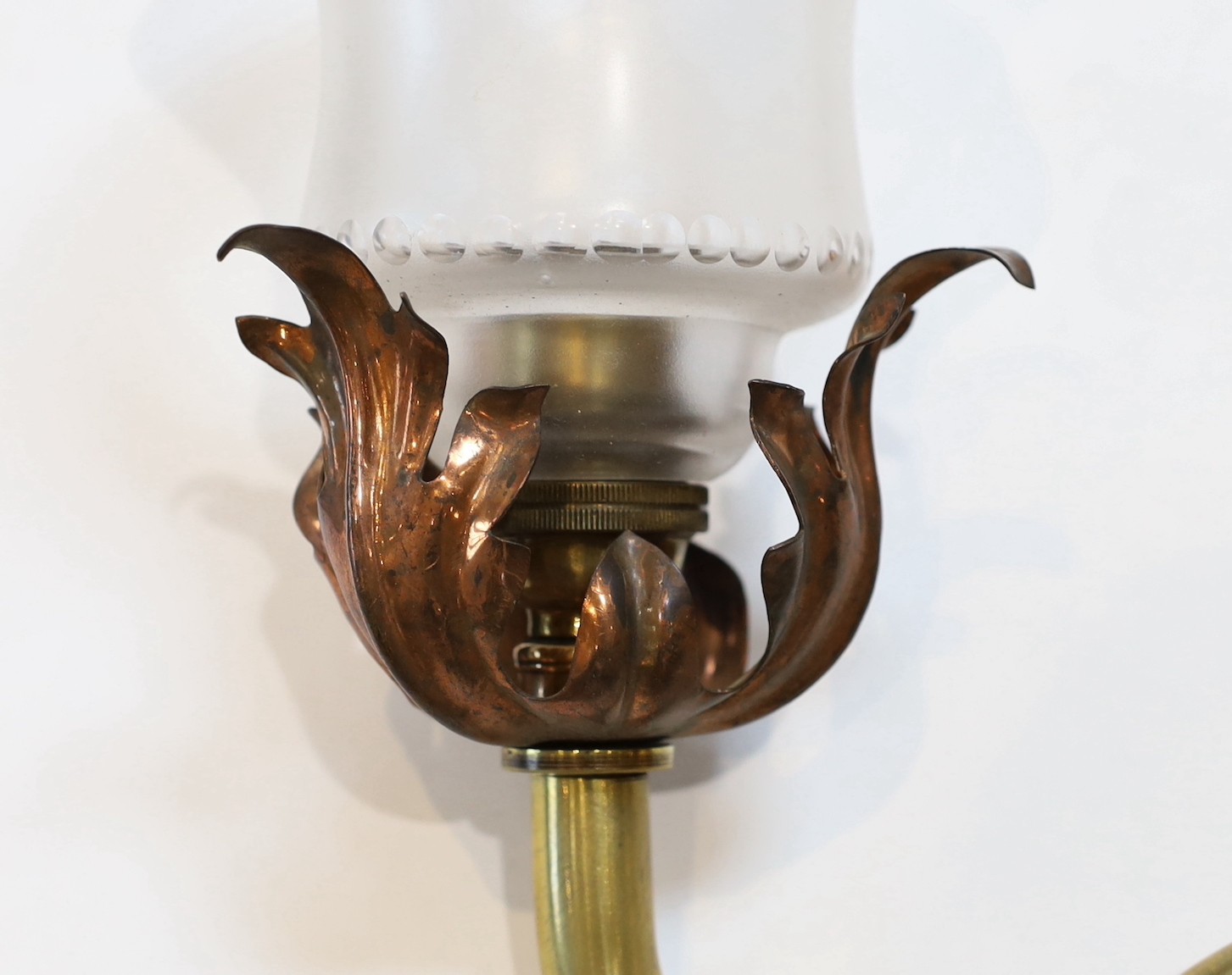 An English Arts & Crafts copper and brass wall light with cut and frosted glass shade, 22cm